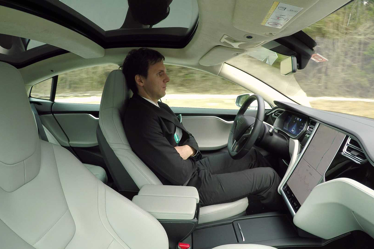 man-sitting-in-tesla-model-s-with-autonomous-self-driving-autopilot-engaged.jpg